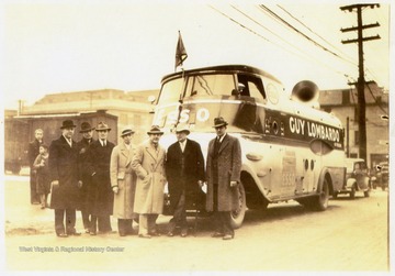 Left to right, men in hats: Hubert Carlin Simms, C.F. Miliar, C.I. Sharpenburg, C.D. Billingsley (All of Standard Oil Co.), Guy Lombardo, Mayor Gordon P. Fought, City Manager R. T. Kemper. Taken shortly after the Mayor welcomed Guy Lombardo to Wheeling. Lombardo's Royal Canadians played a one day engagement at the Capital Theater. The tour of the Esso Marketers was sponsored by the Standard Oil Co.