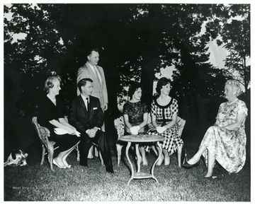 Gathering for the first production of "Anvil" in Charles Town, W. Va. for the West Virginia Centennial. Identified in the photograph: left Seated, Erma Ora Byrd and Robert C. Byrd; far right seated, Julia Davis Adams. "The Anvil" was a play written by Julia Davis about the John Brown Raid for the Civil War Centennial. Her grandparents were from Charles Town where Brown was tried and hanged. Her grandfather witnessed the execution.
