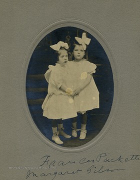 Two girls, Frances Packette and Margaret Gibson, holding hands.