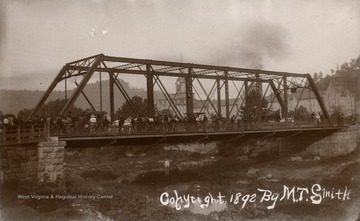 Lynching from a bridge near Weston Hospital; several people on the bridge with carriages and a hearse