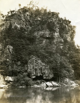 Huge rocky cliffs towering over Eads Ford beyond the Cacapon River.
