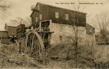Postcard photograph of a grist mill in Shepherdstown, Jefferson County, West Virginia. Note the worker on the left emptying barrels