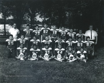 Team portrait of a little league football team coached by George DeAntonis (standing, left) and Whitey Cyphert, (standing, right)