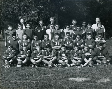 Portrait of a little league football team coached by George DeAntonis, (standing, right) 