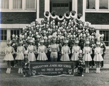 Group portrait of the band and majorettes in full uniform. 
