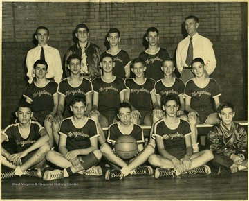 Group portrait of unidentified players, Coach Glen Ellis, standing back row, far right.