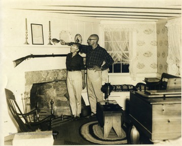 Authors, hunters, and dog breeders, George and Kay Evans pose in the living room of their 18th century home, "Old Hemlock" in Preston County, West Virginia.