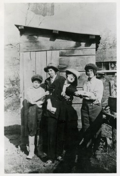 Left to right: Marie Jones, Goldie Brock, Bessie Lemley and Artie Lemley. Coal house in background.