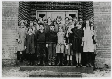 First row: (?), Philip Harmer, James Pitcher, Helen Howell, Mildred Jenkins, Oleta Blasser, June Satterfield. Second Row: Hazel Jenkens, (?), Elizabeth Kirk, Georgia Blasser, Bernardine Poole, Nellie Pitcher, Betty Poole. Third Row: Joseph Shriner, (Teacher), (?), (?), Hayward Hennessey, Buck Poole (John), Lester Gamble.