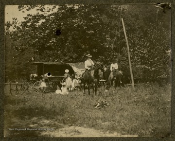 Family camp site, possibly in Monongalia County, W. Va. including a wagon and horsebacking riding.