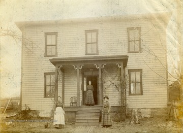 Three unidentified women pose in front of a home in Morgantown, Monongalia County, West Virginia.