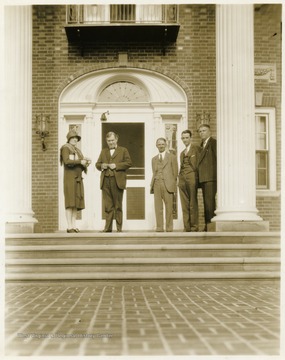 WV Governor Howard Gore and unidentified persons standing on the front steps of the Governor's Mansion, Charleston, W. Va.