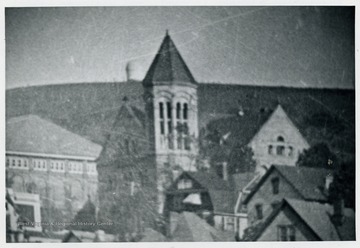 Morgantown as seen in part from Westover, about 1910 or so. Visible on the crest of the hill is the old WVU astronomical observatory (built 1900) which was burned in 1919 to celebrate a football victory. In foreground are the old Commencement Hall, (later Reynolds Hall, torn down to make way for the New Mountainlair). Also visible is the Administration Building (Stewart Hall). From an old glass plate negative in the WVU Library.