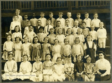 Note: The class is integrated. There are three African-American children in the photograph.