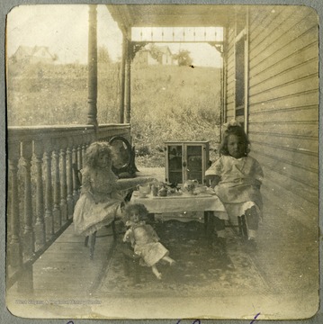 Margaret Mathers and her dolls enjoy tea.