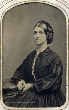 Portrait of the sister of Thomas Jonathan "Stonewall" Jackson. The siblings became estranged after the Civil War broke out. Laura's large sleeve dress and pulled back hair were the fashion during the war.  