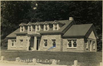 Post card photograph of a stone-cut house located in Braxton County, West Virginia.