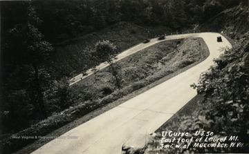 Curve located on Route 50 three miles west of Macomber in Preston County, West Virginia. The image is a post card photograph print.