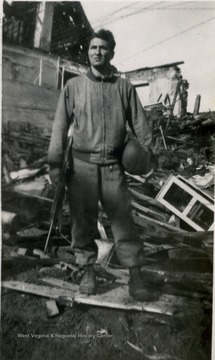This photograph was included in West Virginia University student, Louis Piccola's narrative documenting his military experiences during World War II. The soldier has been identified by descendants as Louis Piccola. Inscribed on the back, "Dutch homes had to be destroyed also because Jerry would not leave."