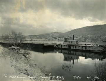 The "Wild Goose" towboat pictured in a winter setting, was powered by steam stern wheel and built by The Charles Ward Engineering Works in Charleston, West Virginia.