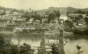 Postcard photograph of the old suspension bridge razed, in order to built a new bridge over the Monongahela connecting Westover and Morgantown, West Virginia. See the original for the correspondence written on the back.