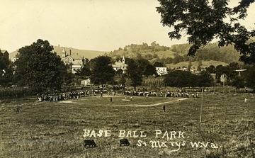Postcard photograph of a baseball park in St. Mary's, West Virginia, with a game in progress.  