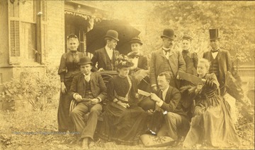 Front Row Left to Right: Mrs. Woolfe; Edd Knight; James Ewing; Miss Etta Hayes; Back Row, L to R: Miss Gypsie Fleming; W. D. Payne; S. S. Green; Mrs. S. S. Green; Miss Ida Fleming; Governor A. B. Fleming. The photograph was taken at S. S. Green's house on Broad Street in Charleston, West Virginia