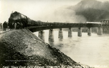 The first train to cross over the new bridge of the Virginian Railway at Deep Water, West Virginia. The river is probably the Kanawha River.