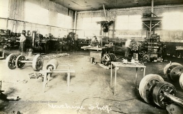 Unidentified employees at work in company's machine shop.