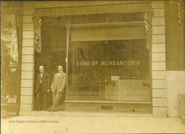 Louis Snyder (left) and Martin Luther Brown (right) standing in the doorway of the Bank of Morgantown. Brown would be appointed Warden of the state prison in Moundsville in 1911.