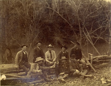 Unidentified engineers, working on the Ohio extension in Southern West Virginia, two men, sitting in the middle, are holding revolvers. 