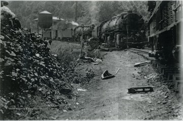Train wreck near water tower in southern West Virginia. The train is property of Nicholas, Fayette &amp; Greenbrier Railroad. It was a coal feeder line that ran from Rainelle to Swiss. 