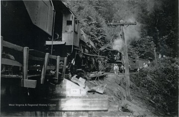 A train wrecked on a coal feeder line, which ran from Rainelle to Swiss. In the photo, unidentified railroad workers among others are surveying the damage. 