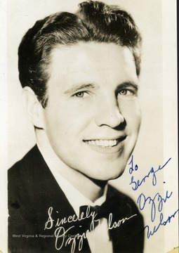 This is an autographed photo of Ozzie Nelson, American actor and star of the television series "Ozzie and Harriet". He performed at the Warner Theater in Morgantown, West Virginia. The photo is signed " To George Ozzie Nelson". 