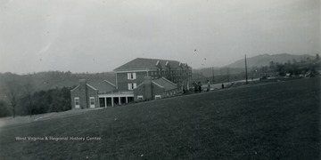 This is a photo of John White Hall at Concord College. The college is located in Athens, West Virginia in Mercer County and is now called Concord University. The building was built in 1939 and was used as a men's dormitory. It was demolished in 2004 to build a new technology center. All persons in the picture are unidentified. 