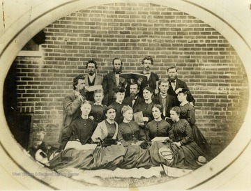 This is a photo of the Moorefield Presbyterian Church choir in Moorefield, West Virginia. The church was located in Hardy County. First Row: Mollie Gilkeson, Miss Annie Forrer, Sallie Taylor, Miss Katie Forrer, Kate McMechen. Second Row: James Nihiser, Nan Hyder, Mag Fravel, Sam Tucker, Miss Sallie Forrer, Luke Kuykendall, Virginia Maslin. Back Row: William H. Violet, William Eberly, John G. Kuhn, Mr. Mohler