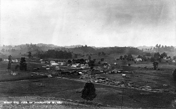 Lumber yard in the foreground of photograph.