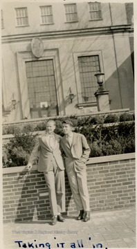 Unidentified student with Mathers "Mike" Barrick (on right) in front of WVU Library (Wise Library). 