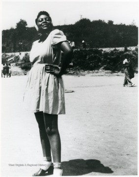 Young African-American woman strikes a pose. Information on p. 128 in "Our Monongalia" by Connie Park Rice. Information with the photograph includes "Courtesy of Bobbie Drew Ward."   