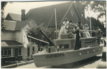 Inscribed on the back of the photo, "The good ship CLOTHESPIN at the 1938 maneuvers with Miss Jeanette Richards the Sweetheart and her Yoemanettes riding in the parade."