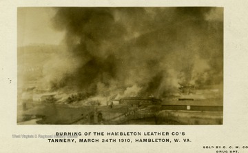Postcard photograph of fire engulfed tannery. Information on photograph includes, "Sold by O. C. M. Co. Drug Dept.".
