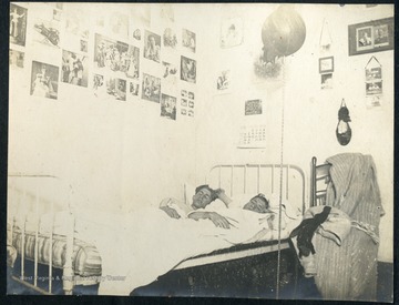 Leonard Hall and roommate asleep in their dorm room. Note the punching bag hanging from the ceiling. 