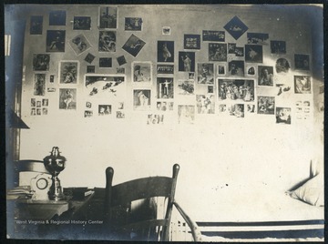 Wall of dorm room covered with photographs.