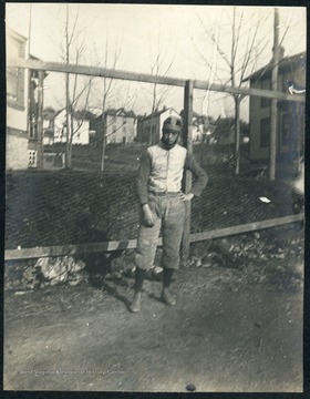 Unidentified WVU student wearing football gear, including a leather helmet.