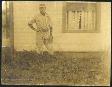 Unidentified student-athlete poses with a fielding glove on his left hand. 