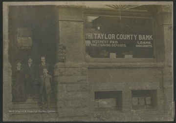 Information with the photograph includes "This group was standing in front of Jannett Building (erected by a dentist of that name who later moved to Charleston.) Building in 1940's was bought by an Italian from Clarksburg named Oliverio and named "Professional Building". It was torn down in 1970's to be replaced by Court House annex. Gene W. Ford had law office on front of 3rd floor about 1929."