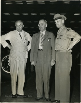 Left to right: Senator Harley M. Kilgore of West Virginia, Senator Harry S. Truman of Missouri, and Lt. Col. Roy E. Ludick, Representative of Vultee's Fort Worth Plant. 