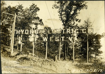 The entrance sign to the dam, outlined in lights, reads, "Hydro - Electric Co. of West Virginia".