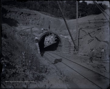 Rocks are lowered to add to the walls of a railroad tunnel
