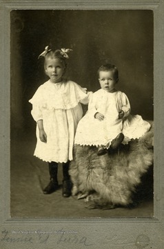 Two little girls pose for portrait.